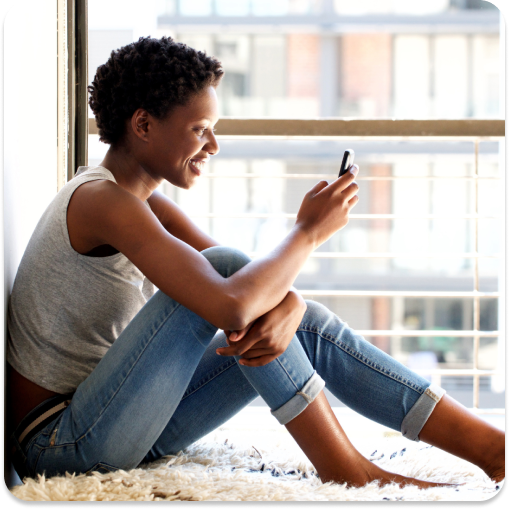 Woman sitting at window on phone