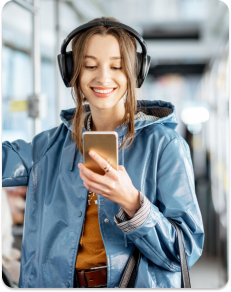 Woman smiling on phone with headphones